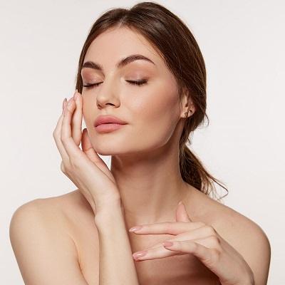 Portrait of young beautiful woman with perfect smooth skin isolated over white background. Tenderness and sensuality